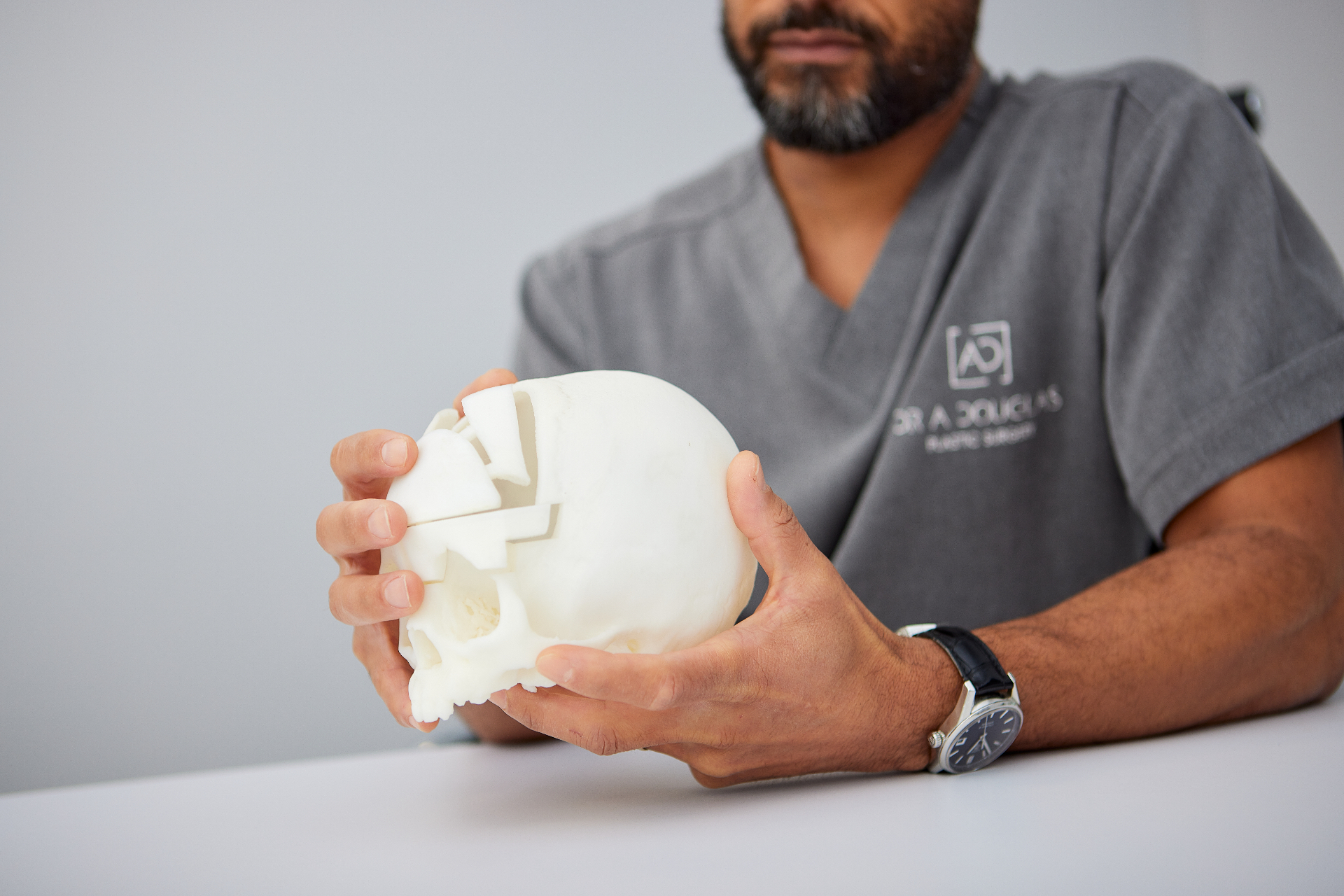 Dr. Arnold Douglas holding a 3D-printed skull model